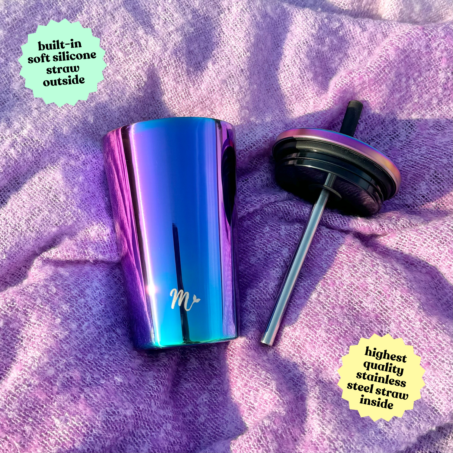 14 oz iridescent stainless steel cup with a built-in soft silicone straw, placed on a purple textured fabric, with the lid and high-quality stainless steel straw set beside it.